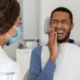 Patient with tooth pain at Nice Smile Dentists
